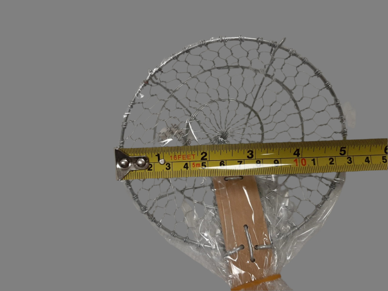 Close-up of long stainless handle on London Wok D6S5 5-inch wire skimmer for safe lifting over hot oil